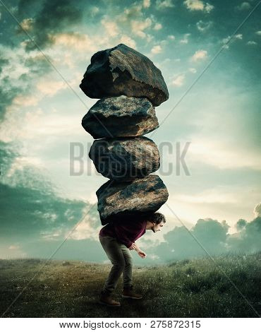 Man Carries A Stack Of Heavy Rocks.