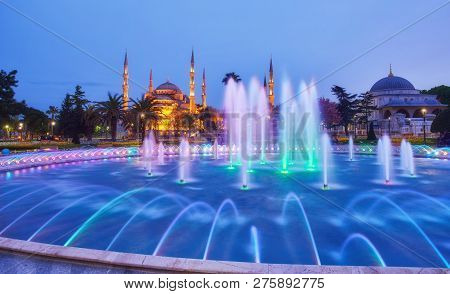 Colorful Spring Sunset In Sultan Ahmet Park In Istanbul, Turkey, Europe. Colorful Fountain On The Ba
