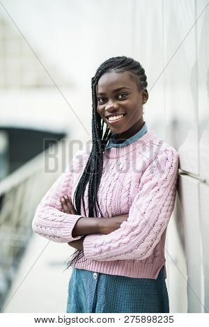 Young African Woman With Crossed Hands Standing In Office Hall