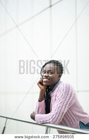 Young Pretty Afro American Woman Relaxing On Handsrails In Modern Office