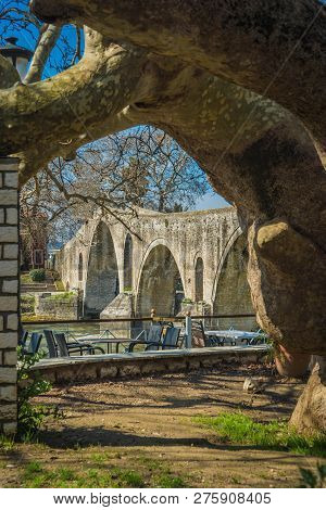 Landscape With Giant Tree Near Medieval Bridge Over River Arahthos In Arta, Greece