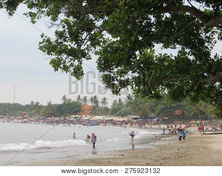 Anyer, Indonesia - June 24, 2018: Crowd Of People Doing Activities At Sambolo Beach. Month Of June I