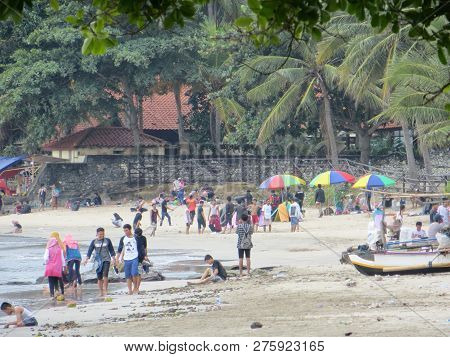 Anyer, Indonesia - June 24, 2018: Crowd Of People Doing Activities At Sambolo Beach. Month Of June I