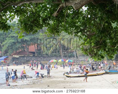 Anyer, Indonesia - June 24, 2018: Crowd Of People Doing Activities At Sambolo Beach. Month Of June I