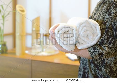 Chambermaid Holding Clean Towels In Spa. Clean White Towel In A Spa Centre. Staff Cleaning Lady Hold