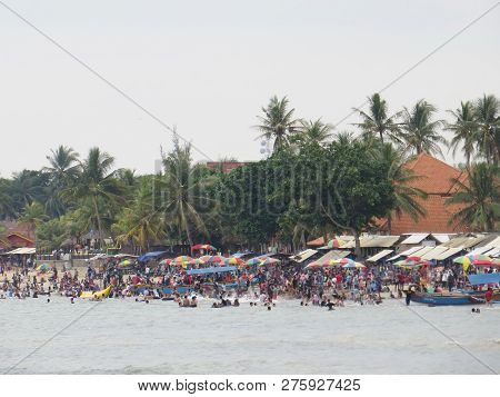 Anyer, Indonesia - June 24, 2018: Crowd Of People Doing Activities At Sambolo Beach. Month Of June I