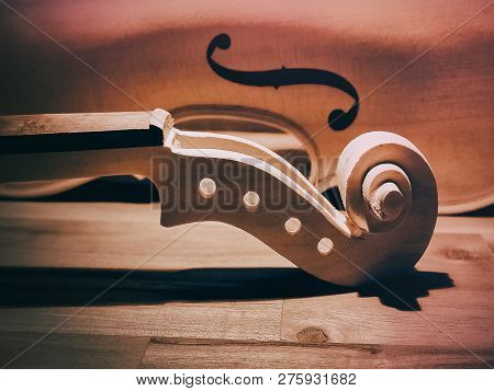 In Selective Focus Of Raw Violin Neck And Scroll With Peghole,pegbox,on Wooden Board.vintage And Art