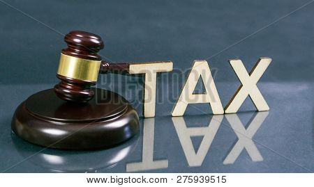 Tax Law Concept. Word Tax With Gavel And Money On The Table.