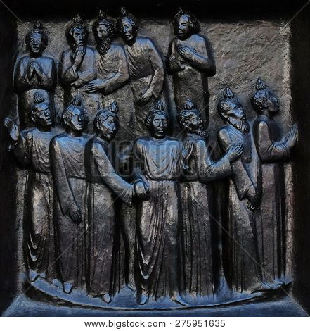 ZURICH, SWITZERLAND - JUNE 23, 2018: The outpouring of the Holy Spirit on Pentecost, relief on the door of the Grossmunster (