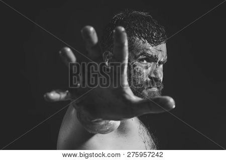 Man With Bloody Beard Make Stop Gesture On Black Background. Hipster With Brutal Bearded Face. Hallo