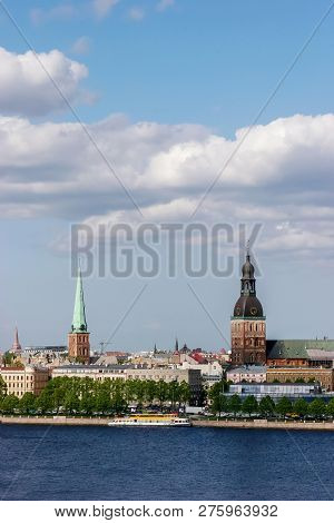 Riga, Capital City Of Latvia. View Of Church And Cathedral. View Of Old Riga With River In The Foreg