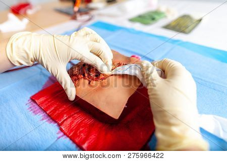 German Military Medic Practice Bleeding Control On A Wound Dummy