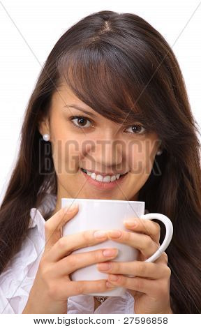 Beautiful businesswoman drinking coffee in the office.