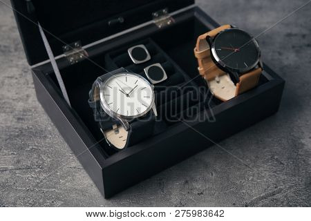 Case With Stylish Wrist Watches On Gray Background. Fashion Accessory