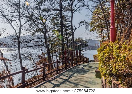 Concrete Walkway With Wooden Railing At Next To Oriental Gazebo At Yesan Lake Ecological Park In Yes