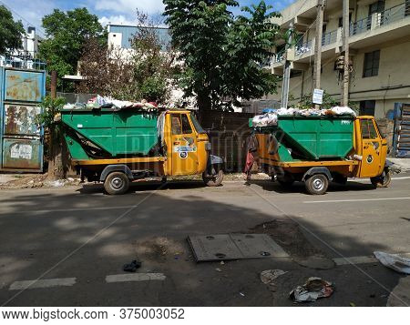 Closeup Of Garbage Collecting Green And Yellow Color Auto Parking On Roadside