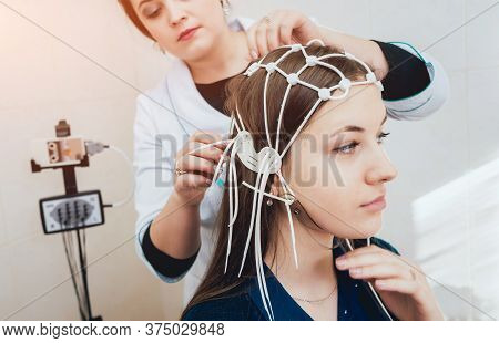 Doctor And Patient With Encephalography Electrode. Electroencephalogram