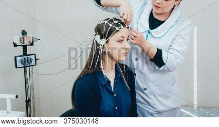 Doctor And Patient With Encephalography Electrode. Electroencephalogram