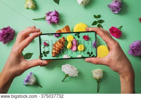 Food Blog - Blogger Taking Picture Of Macarons And Croissant With Phone
