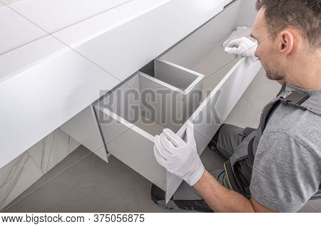 Caucasian Furnishing Technician In His 40s Finishing Modern And Elegant Custom Made Bathroom Furnitu