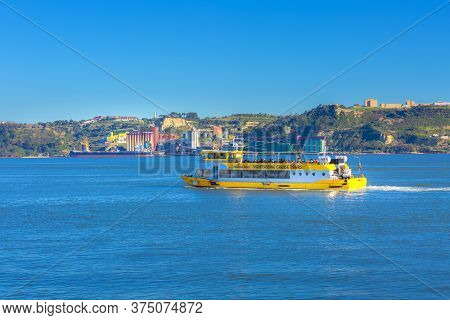Lisbon, Portugal - March 27, 2018: Yellow Sightseing Tour Boat In The River Tagus