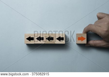 Hand Putting Putting Cubes Block For Change Direction Of Red Arrow From Left To Right And Black Arro