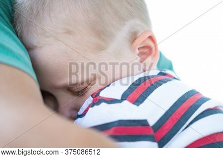 A Young Child Is Sleeping In His Fathers Safe And Protective Embrace While On Walk. Single Father Co
