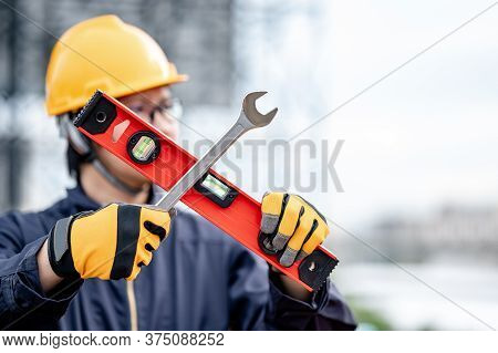 Male Asian Mechanic Or Maintenance Worker Man Wearing Protective Suit And Helmet Holding Wrench And 