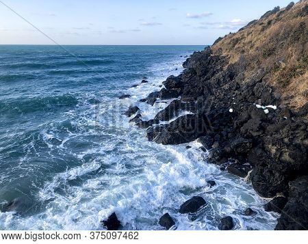 Solidified Lava Near Water Of Sea In Jeju Island. South Korea.