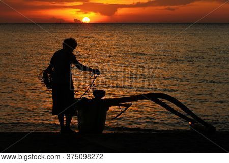 Silhouette Of A Fishing Boat At Dusk On The North Coast Of The Island Of Java