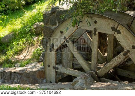 Old Wooden Water Pumping Wheel On River