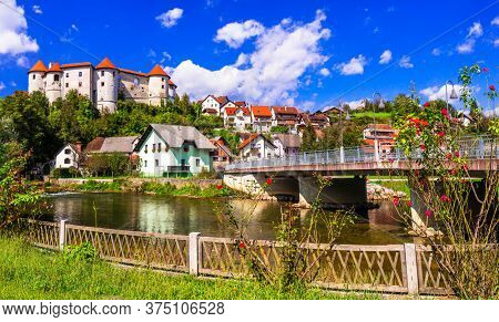Slovenia landmarks and travel - medieval castle and village Zuzemberk over Krka river