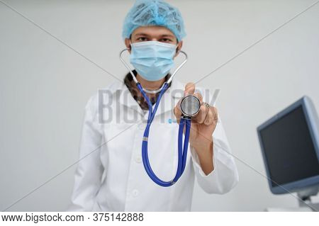 The Doctor With The Masck And Stethoscope In Hand, Close View