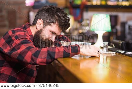 Man With Tired Face Sit Alone At Bar Counter