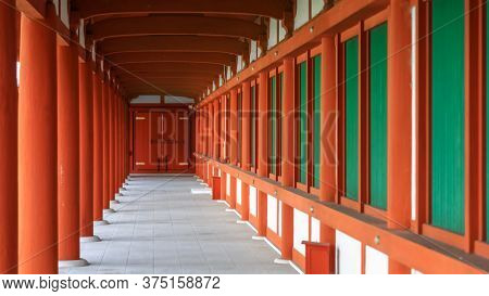 Tall red pillars and windows of historic Yakushi-ji temple in Nara, Japan.