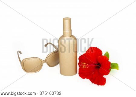 Sunscreen Spray Lotion Golden Bottle, Tropical Flower And Sun Glasses On The White Background.