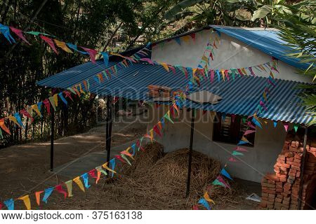 Buddhist Praying Flags Attatched To A Small House In A Nepalese Village, Annapurna Circuit