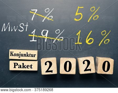 Conceptual Image With Wooden Blocks On A Chalkboard For Economic Stimulus Package For Germany.
