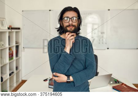 Teaching Online. Portrait Of Young Happy Caucasian Man Teacher Wearing Glasses Standing Against Whit