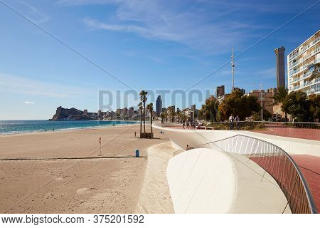 Benidorm, Alicante, Spain - November 27, 2019: People Walk Along The Fantastic Modern Promenade Of P