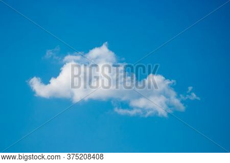 One Cloud Drifting Overt Clear Blue Sky. Sky Background