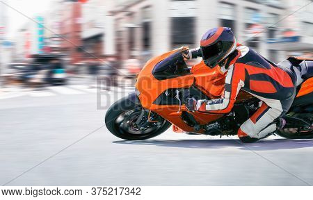 Motorcycle Leaning Into A Fast Corner In Downtown