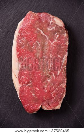 rib eye beef steak on the black background