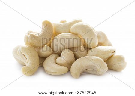 กองของมะม่วงหิมพานต์ถั่วบนพื้นสีขาวที่แยกต่างหาก