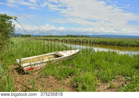An Old Wooden Fishing Boat In The Wetland Area Of Isola Della Cona In Friuli-venezia Giulia, North E