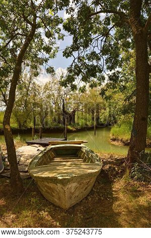 An Old Wooden Fishing Boat In The Wetland Area Of Isola Della Cona In Friuli-venezia Giulia, North E
