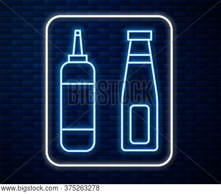 Glowing Neon Line Sauce Bottle Icon Isolated On Brick Wall Background. Ketchup, Mustard And Mayonnai