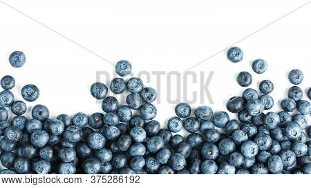 Tasty Blueberries Fruit Are Scattered On A White Background. Frame