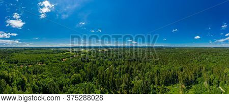 Beautiful Panoramic Aerial Drone View Over A Green, Fresh Forest With A Blue Sky In Summer - Symbol 