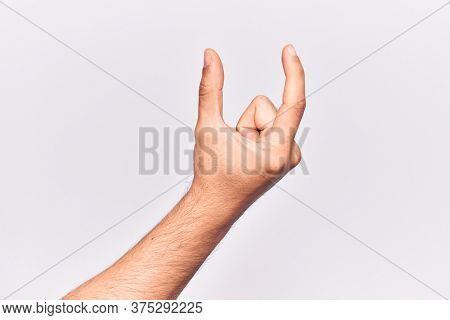 Close up of hand of young caucasian man over isolated background picking and taking invisible thing, holding object with fingers showing space 